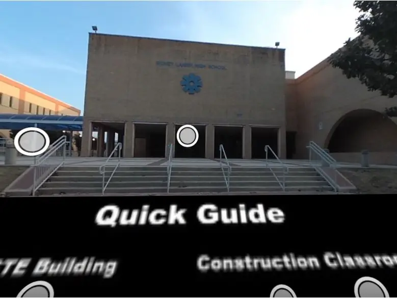 Exterior view of Lanier High School’s CTE building, with broad steps and metal railings leading to a covered entrance beneath a blue school emblem.