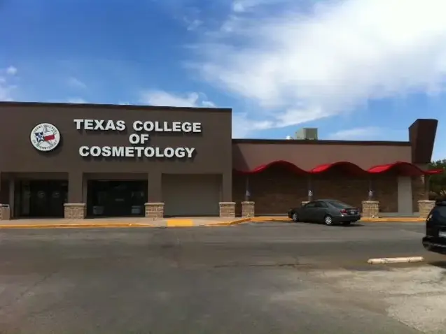 Front exterior of Texas College of Cosmetology, with the school name displayed above the entrance on a brown facade beneath a blue sky.