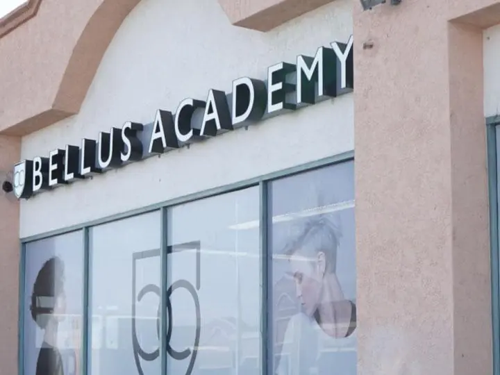 Exterior of Bellus Academy in Chula Vista, with the Bellus Academy sign above the storefront windows and a window listing the school’s locations.